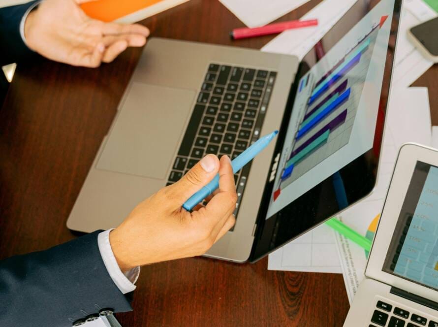 Free A Person in Black Suit Holding a Pen Stock Photo
