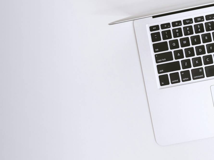 Free Aerial view of a sleek laptop keyboard on a clean, white surface, ideal for tech backgrounds. Stock Photo